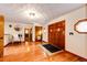Spacious foyer featuring hardwood floors, a stylish light fixture, and a wooden front door at 530 Windmill Rd, Castle Rock, CO 80108