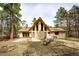 Home exterior with mature trees, large backyard, and patio at 530 Windmill Rd, Castle Rock, CO 80108