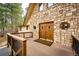 Inviting front door and deck featuring stone accents and a 'Welcome' mat at 530 Windmill Rd, Castle Rock, CO 80108