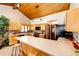 Updated kitchen boasts wood cabinets, long countertops, decorative tile backsplash, and vaulted wood plank ceiling at 530 Windmill Rd, Castle Rock, CO 80108