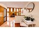 Bright living space with hardwood floors, wood-paneled walls, and vaulted ceilings at 530 Windmill Rd, Castle Rock, CO 80108