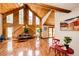 Inviting living room with vaulted wood ceilings, hardwood floors, and large windows with nature views at 530 Windmill Rd, Castle Rock, CO 80108