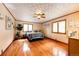 Well-lit main bedroom with hardwood floors, two windows, ceiling fan, and neutral wall paint at 530 Windmill Rd, Castle Rock, CO 80108