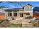 A stunning brick house featuring a stone patio with outdoor seating and a built in stone seating area at 7430 E Bayaud Ave, Denver, CO 80230