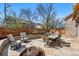 Outdoor patio featuring a stone surface, a dining table, a fire pit, and seating areas at 7430 E Bayaud Ave, Denver, CO 80230