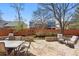 Outdoor patio featuring a stone surface, a dining table, a fire pit, and various seating areas at 7430 E Bayaud Ave, Denver, CO 80230