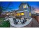 Outdoor space with stone patio, dining table, lounge chairs, and fire pit with a backyard view at 7430 E Bayaud Ave, Denver, CO 80230