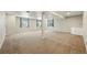 Spacious basement area with neutral carpet and ample natural light at 7430 E Bayaud Ave, Denver, CO 80230