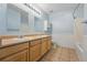 Bathroom featuring a double vanity, two mirrors, and tile flooring at 7430 E Bayaud Ave, Denver, CO 80230