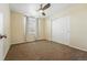 Cozy bedroom featuring a ceiling fan, neutral walls, and a double door closet at 7430 E Bayaud Ave, Denver, CO 80230