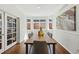 Inviting dining room with hardwood floors, bay windows, and stylish decor at 7430 E Bayaud Ave, Denver, CO 80230