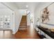 Inviting foyer with hardwood floors, a staircase, and an elegant console table at 7430 E Bayaud Ave, Denver, CO 80230
