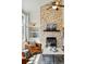 Inviting living room showcasing stone fireplace, built-in shelves, and comfortable furniture at 7430 E Bayaud Ave, Denver, CO 80230