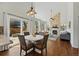 Open-concept living space featuring hardwood floors, dining area, and sliding glass doors to the backyard at 7430 E Bayaud Ave, Denver, CO 80230
