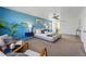 Spacious primary bedroom featuring a calming blue accent wall, neutral furnishings, and carpet floors at 7430 E Bayaud Ave, Denver, CO 80230