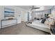 Bright primary bedroom with a cozy seating area, carpet floors, and neutral décor at 7430 E Bayaud Ave, Denver, CO 80230