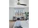 Bright and cozy bedroom featuring seating area and ceiling fan at 7430 E Bayaud Ave, Denver, CO 80230