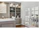 Stylish office space with built-in shelving, hardwood floors, and adjacent dining room with french doors at 7430 E Bayaud Ave, Denver, CO 80230