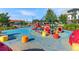 A vibrant community playground with colorful climbing structures, slides, and soft, safe flooring at 7430 E Bayaud Ave, Denver, CO 80230