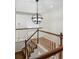 Staircase with railing and carpeted steps leads to the upper level, bathed in natural light at 7430 E Bayaud Ave, Denver, CO 80230