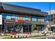 Logan House Coffee Company & Crisp & Green featuring a sleek, modern design with large windows and outdoor seating at 7430 E Bayaud Ave, Denver, CO 80230