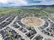 Aerial view of a neighborhood with homes surrounding a large construction area at 9804 Rosalee Peak St, Littleton, CO 80125