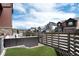 Relaxing backyard with artificial grass, modern fence and outdoor seating area at 9804 Rosalee Peak St, Littleton, CO 80125