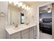 Bright bathroom with dual sink vanity, modern fixtures, and access to the primary bedroom suite at 9804 Rosalee Peak St, Littleton, CO 80125