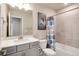 The bathroom features a combination tub and shower and a single sink vanity at 9804 Rosalee Peak St, Littleton, CO 80125