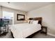Bedroom includes a comfortable bed, TV, and window offering natural light, creating a cozy and inviting space at 9804 Rosalee Peak St, Littleton, CO 80125