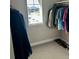 Well-organized closet with a variety of clothes hanging and shoes neatly lined up, illuminated by natural light at 9804 Rosalee Peak St, Littleton, CO 80125