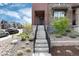 Home's covered entrance featuring stylish stonework and manicured landscaping at 9804 Rosalee Peak St, Littleton, CO 80125