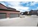 Exterior view showcasing the garage with solar panels and other homes in the neighborhood at 9804 Rosalee Peak St, Littleton, CO 80125