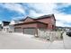 Exterior view of home showing a large garage with an adjacent gated patio area at 9804 Rosalee Peak St, Littleton, CO 80125