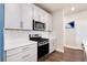 Well-lit modern kitchen with white cabinets, stainless steel appliances, and stylish tile backsplash at 9804 Rosalee Peak St, Littleton, CO 80125