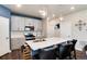 Modern kitchen island features stainless steel appliances, white countertops, and barstool seating at 9804 Rosalee Peak St, Littleton, CO 80125