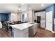 Modern kitchen island features stainless steel appliances, white countertops, and barstool seating at 9804 Rosalee Peak St, Littleton, CO 80125