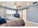 Comfortable main bedroom boasts a ceiling fan, large bed with decorative pillows and bright window at 9804 Rosalee Peak St, Littleton, CO 80125