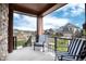 Covered front porch with seating overlooking the street at 9804 Rosalee Peak St, Littleton, CO 80125