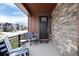 Cozy covered front porch furnished with comfortable seating, perfect for relaxing outdoors at 9804 Rosalee Peak St, Littleton, CO 80125