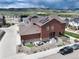 Beautiful home featuring a private fenced patio, professional landscaping, and solar panels against a mountain backdrop at 9804 Rosalee Peak St, Littleton, CO 80125