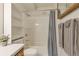 Compact bathroom featuring a shower-tub combo and a single sink vanity at 13606 E Bates Ave # 304, Aurora, CO 80014