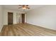 Bedroom features a ceiling fan, wood floors and doors to bathroom and closet at 13606 E Bates Ave # 304, Aurora, CO 80014