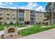 Well-maintained condo building with manicured lawn and visible signage for easy identification at 13606 E Bates Ave # 304, Aurora, CO 80014