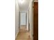 Hallway featuring wood floors and multiple doors leading to other rooms at 13606 E Bates Ave # 304, Aurora, CO 80014