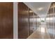 Hallway with many storage units with key lock and natural light shining from window at end of hall at 13606 E Bates Ave # 304, Aurora, CO 80014
