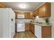 Bright kitchen featuring white appliances, wooden cabinets, and updated countertops at 13606 E Bates Ave # 304, Aurora, CO 80014