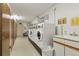 Functional laundry room equipped with multiple washers and dryers and utility sink at 13606 E Bates Ave # 304, Aurora, CO 80014