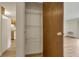 Open pantry shows storage with wire shelving, adjacent to a full-size refrigerator and doorway at 13606 E Bates Ave # 304, Aurora, CO 80014