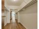 Walk-in closet with laminate flooring, shelving, and a view into another room at 13606 E Bates Ave # 304, Aurora, CO 80014